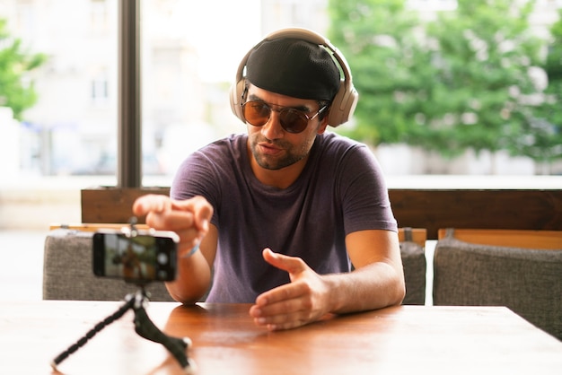 A young person speaking on camera and doing online seminar, internet course