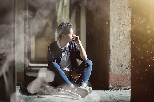 A young person with a baseball bat and a skateboard in an abandoned house