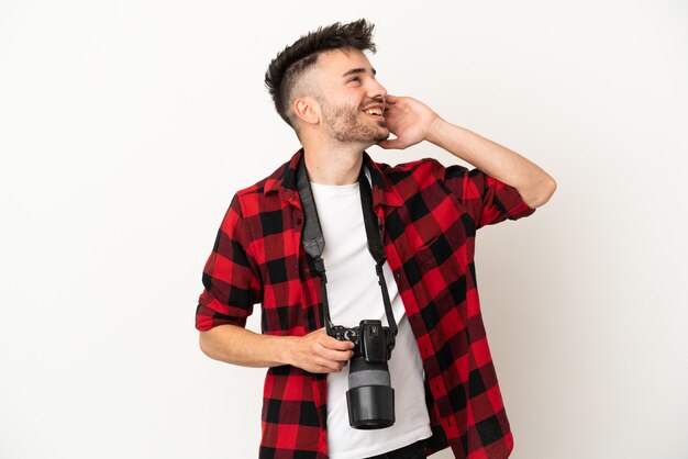 Young photographer caucasian man isolated on white background thinking an idea