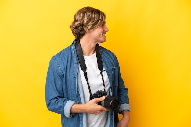 Young  photographer over isolated background