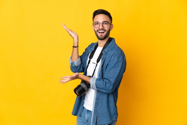 Young photographer over isolated background