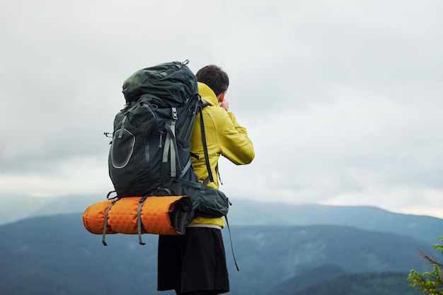 Young photographer makes photos Majestic Carpathian Mountains Beautiful landscape of untouched nature