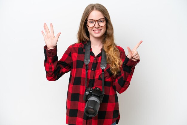 Young photographer pretty woman isolated on white background counting seven with fingers