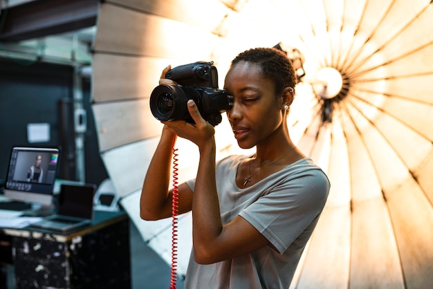 Young photographer standing in front of a reflective umbrella