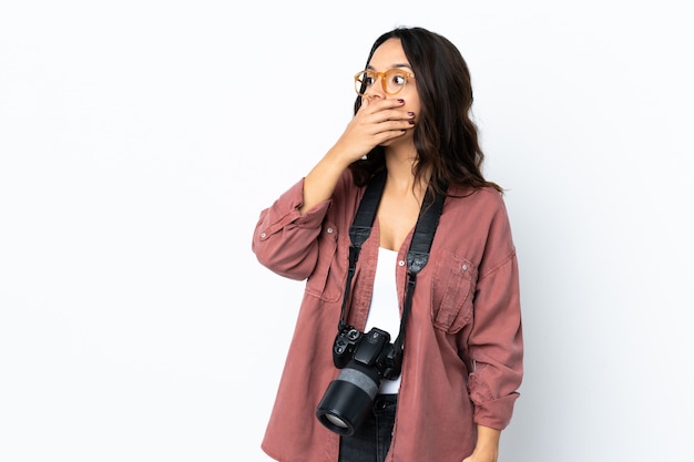 Young photographer woman over isolated white doing surprise gesture while looking to the side