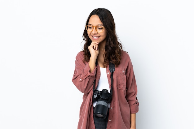 Young photographer woman over isolated white looking to the side and smiling