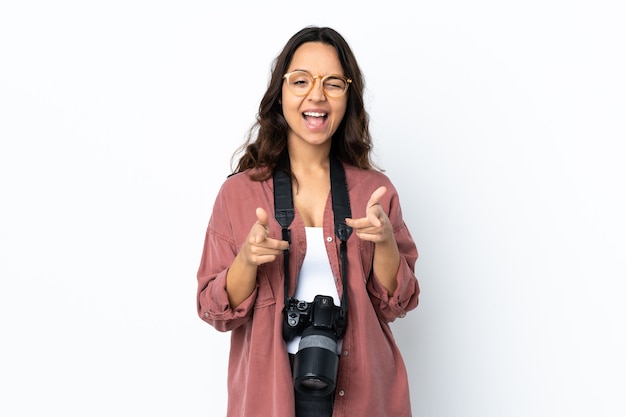 Young photographer woman over isolated white pointing to the front and smiling