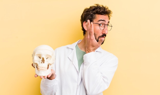 Young physician holding a skull