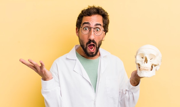 Young physician holding a skull