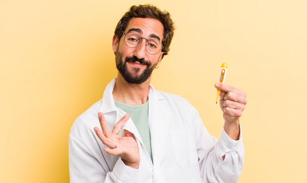 Young physician holding a thermometer