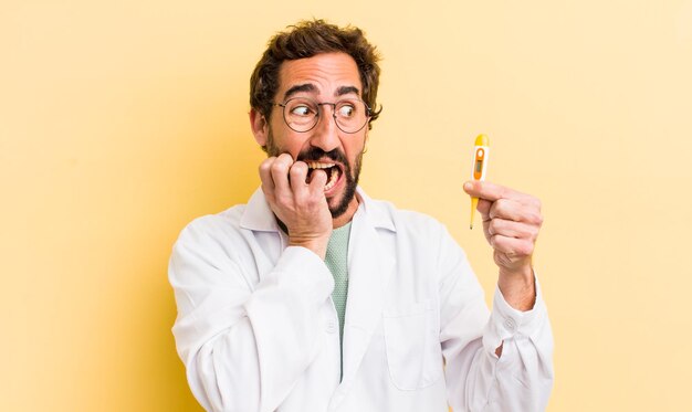 Young physician holding a thermometer