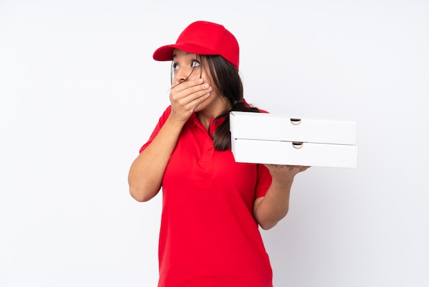 Young Pizza delivery girl over isolated white background covering mouth and looking to the side
