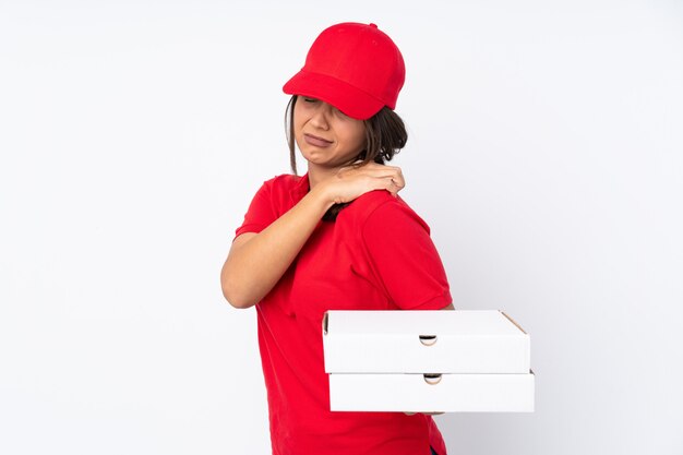 Young Pizza delivery girl over white suffering from pain in shoulder for having made an effort