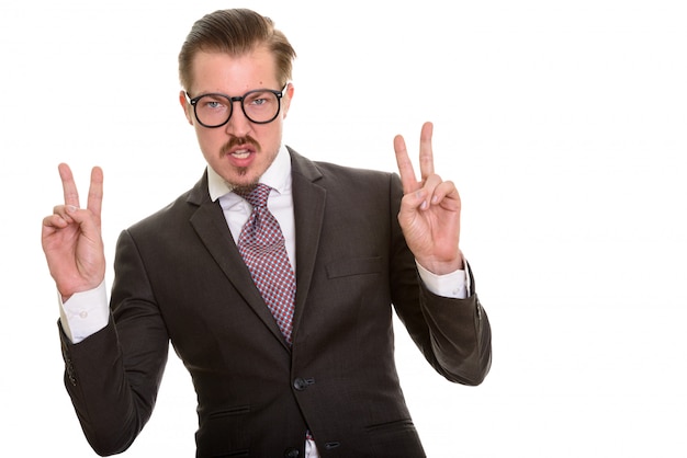 Young playful Caucasian businessman making peace sign