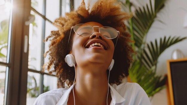 young pleased happy cheerful cute beautiful business woman sit indoors in office using laptop computer listening music with earphones