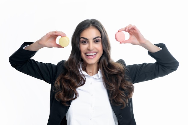 Young pleased woman isolated over white isolated background eating macaroons Girl eat french macarons