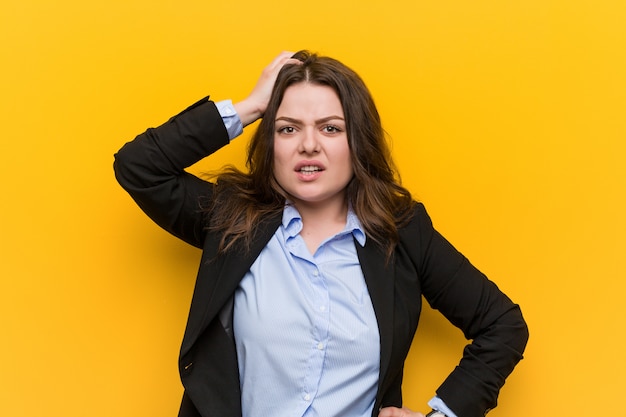 Young plus size caucasian business woman being shocked, he has remembered important meeting.