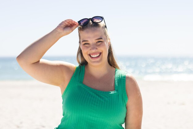 Young plus size Caucasian woman enjoys a sunny beach day