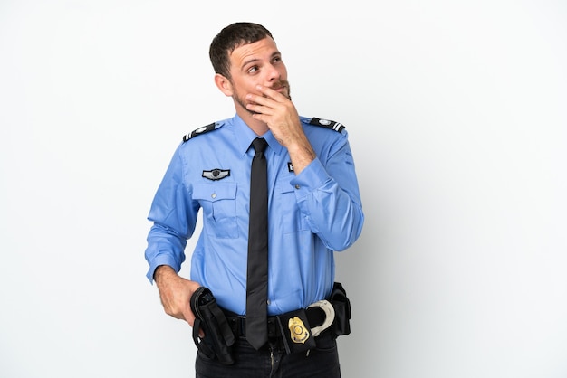 Young police Brazilian man isolated  on white background looking up while smiling