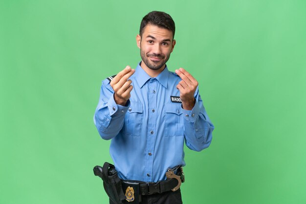 Young police caucasian man over isolated background making money gesture