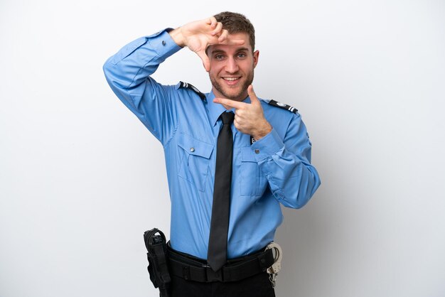 Young police caucasian man isolated on white background focusing face Framing symbol