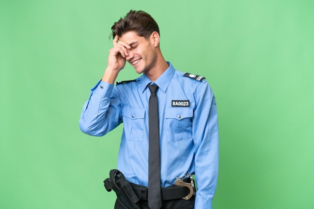 Young police man over isolated background laughing