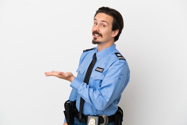 Young police man over isolated background white presenting an idea while looking smiling towards