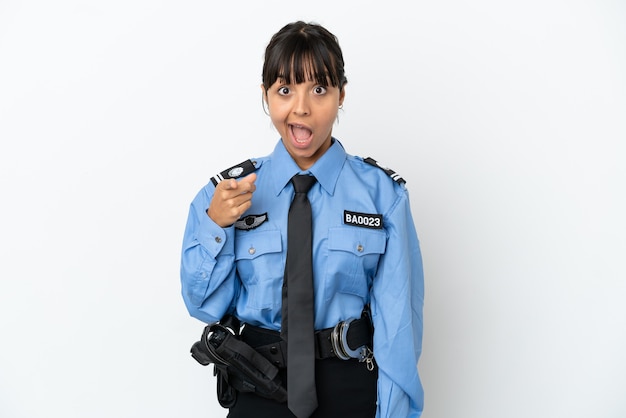 Young police mixed race woman isolated background surprised and pointing front