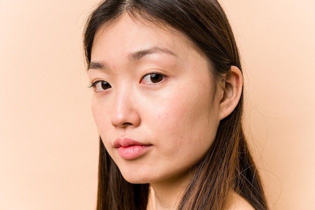 Young portrait asian woman isolated on beige background