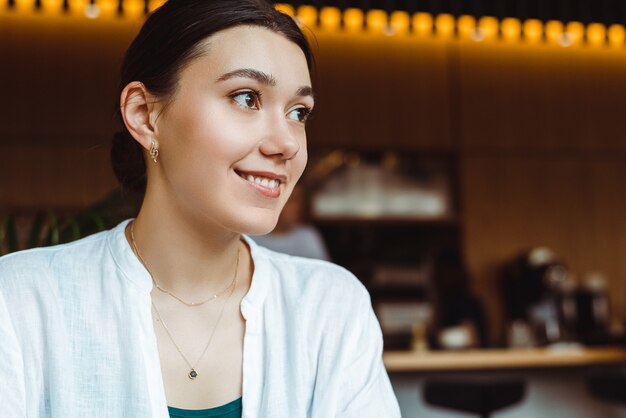 Young portrait of cheerful woman, smiling to camera