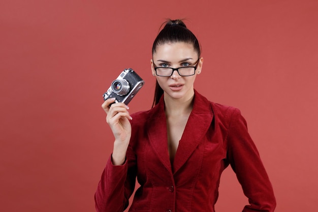 Young positive caucasian woman hold old vintage camera