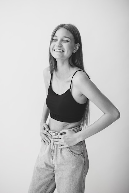 Young positive girl on a white background. Black and White.