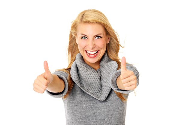 a young positive woman showing ok sign over white background