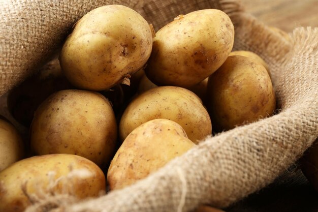 Young potatoes on sackcloth close up