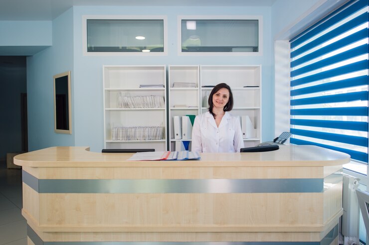 Young practitioner doctor working at the clinic reception desk