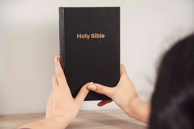 Young prayer woman holding Bible