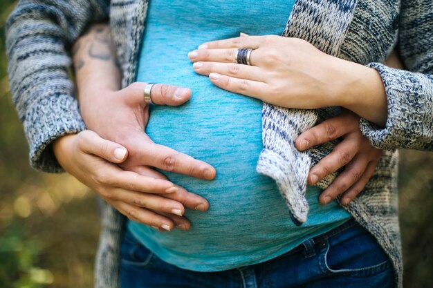 Young pregnant couple in the park