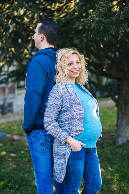 Young pregnant couple in the park