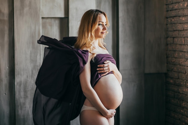 Young pregnant woman in colorful fabric