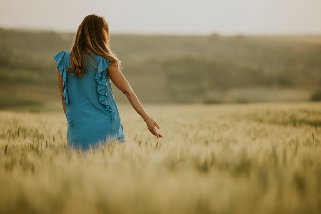 Young pregnant woman in the field