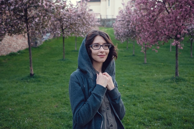 A young pregnant woman in a garden from the sakur in the heart of Warsaw.