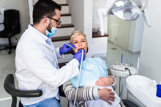 Young pregnant woman having dental treatment.