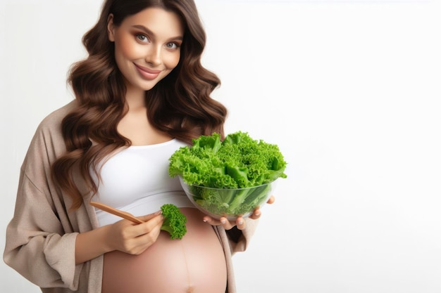 Young pregnant woman holding a bowl with green healthy salad Healthy eating during pregnancy