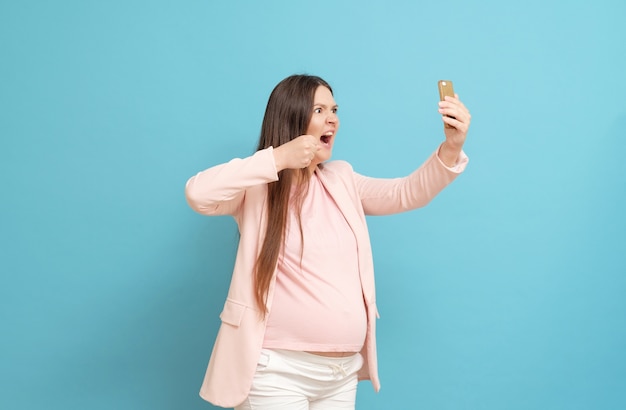 Photo young pregnant woman in a pink t-shirt