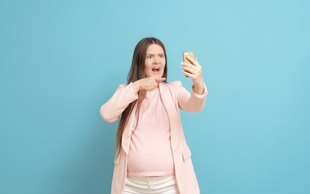 Young pregnant woman in a pink t-shirt