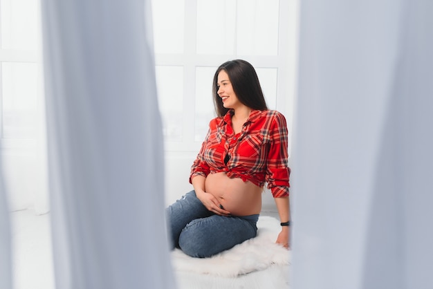 Young pregnant woman posing