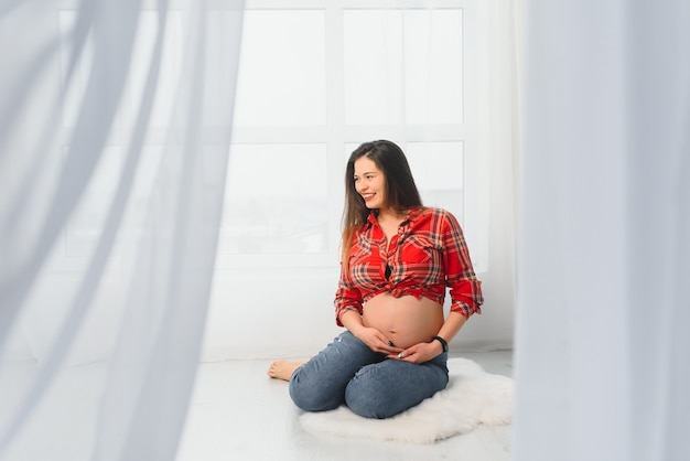 Young pregnant woman posing