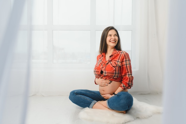 Young pregnant woman posing