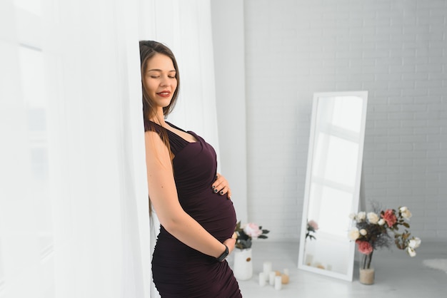 Young pregnant woman posing