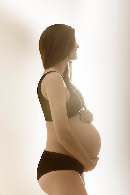 Young pregnant woman in profile